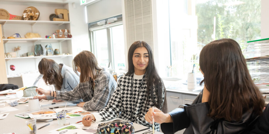 Trinity Sixth Form Academy art students painting in lesson